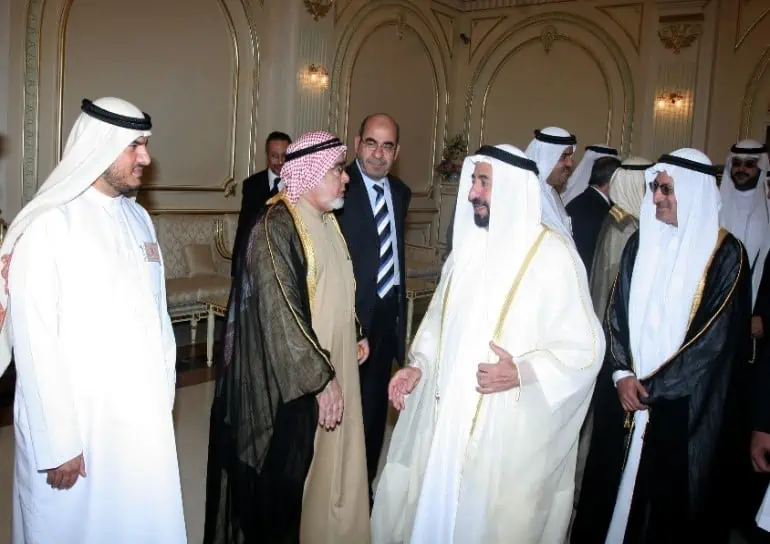 A group of men in traditional clothing standing together, showcasing their cultural heritage.