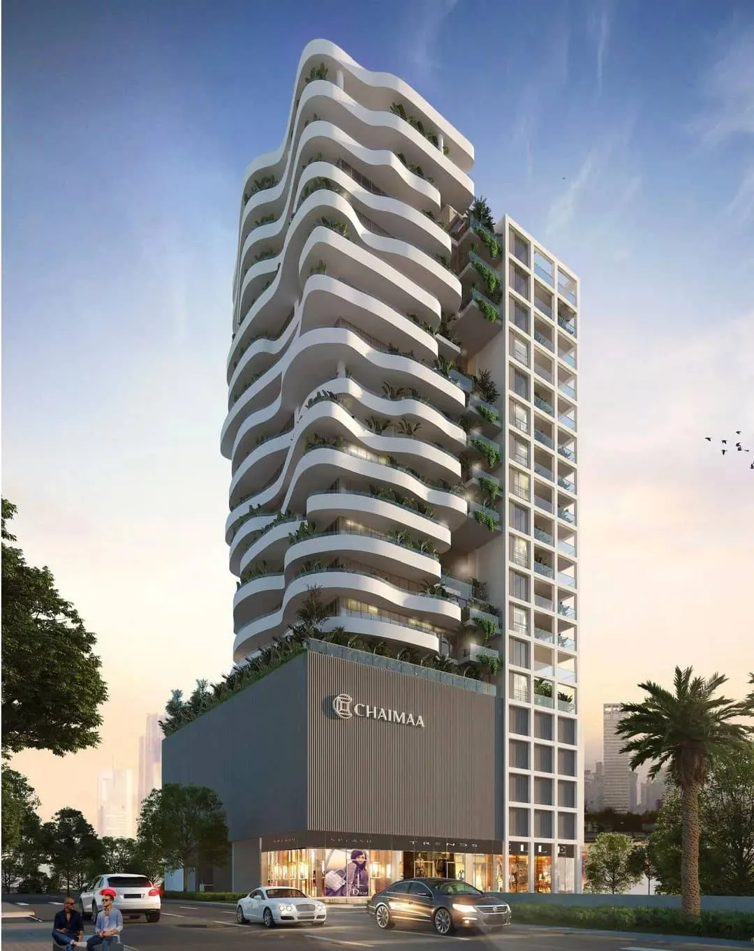  A modern high-rise building features undulating balconies, abundant greenery, and the name "Chaimaa" on its facade